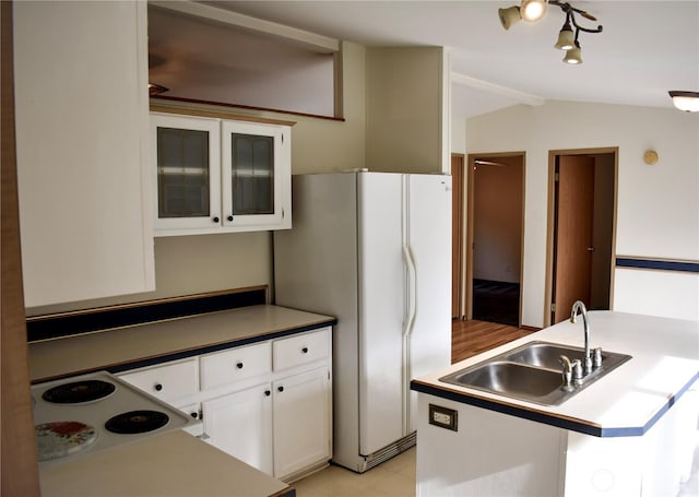 3060 NE Mcwilliams Rd Unit 54, Bremerton, WA 98311 - kitchen featuring a sink, vaulted ceiling, white cabinets, white appliances, and glass insert cabinets