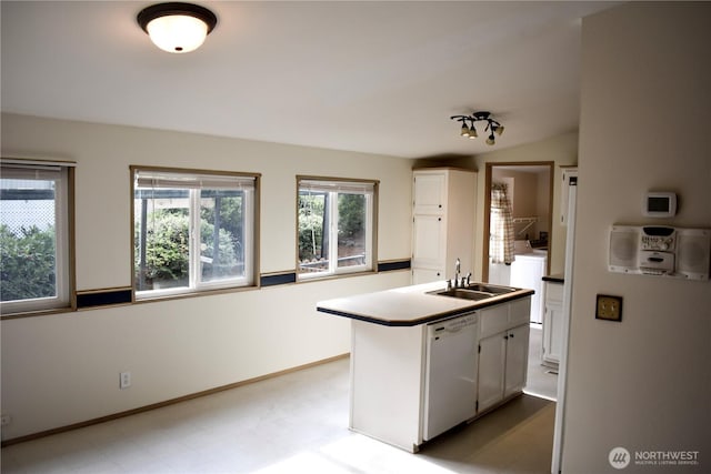 3060 NE Mcwilliams Rd Unit 54, Bremerton, WA 98311 - kitchen featuring white dishwasher, a sink, washer / dryer, white cabinets, and baseboards