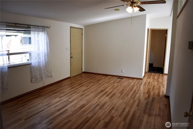 3060 NE Mcwilliams Rd Unit 54, Bremerton, WA 98311 - spare room featuring a ceiling fan, wood finished floors, baseboards, and vaulted ceiling