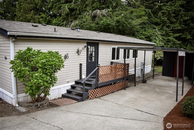 3060 NE Mcwilliams Rd Unit 54, Bremerton, WA 98311 - back of house with driveway and a carport