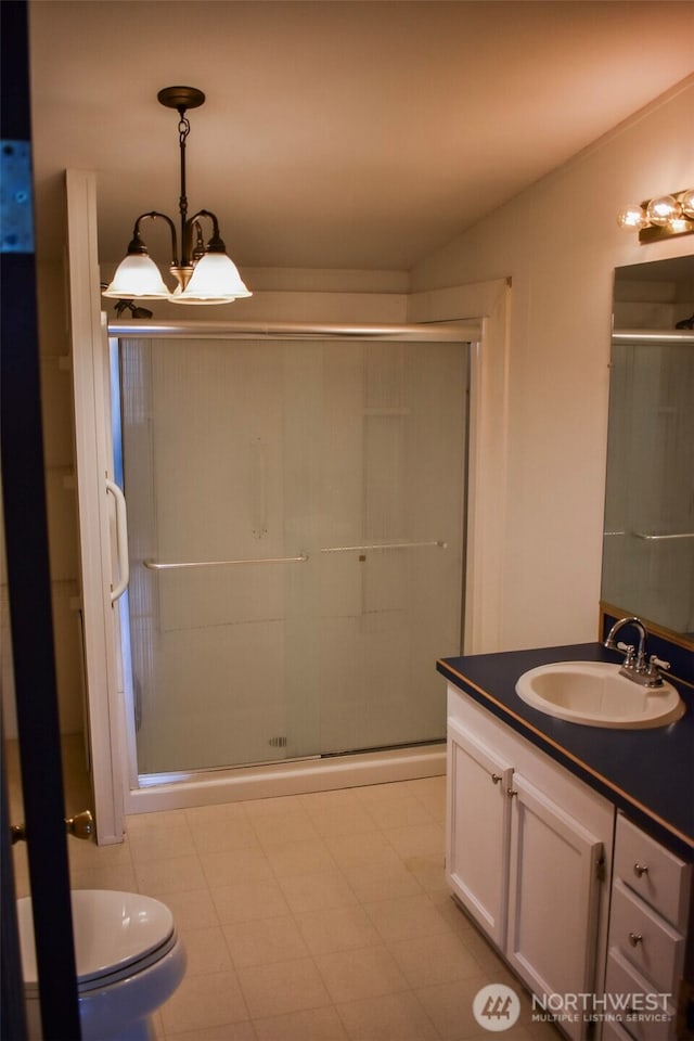 3060 NE Mcwilliams Rd Unit 54, Bremerton, WA 98311 - full bathroom featuring vanity, a stall shower, a chandelier, and toilet