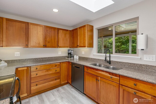 1728 106th St SW, Everett, WA 98204 - kitchen featuring appliances with stainless steel finishes, a skylight, a sink, brown cabinets, and recessed lighting