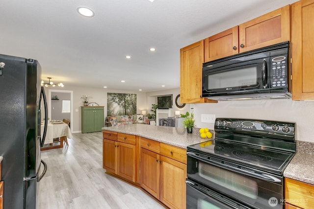 1728 106th St SW, Everett, WA 98204 - kitchen featuring black appliances, light wood-style floors, recessed lighting, brown cabinets, and a peninsula