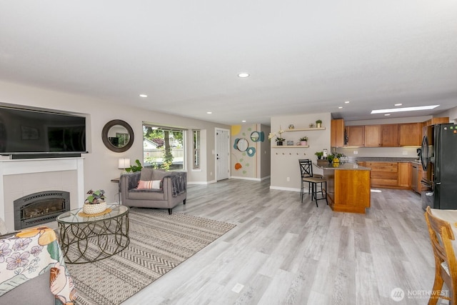 1728 106th St SW, Everett, WA 98204 - living room featuring light wood-style flooring, recessed lighting, a fireplace, and baseboards
