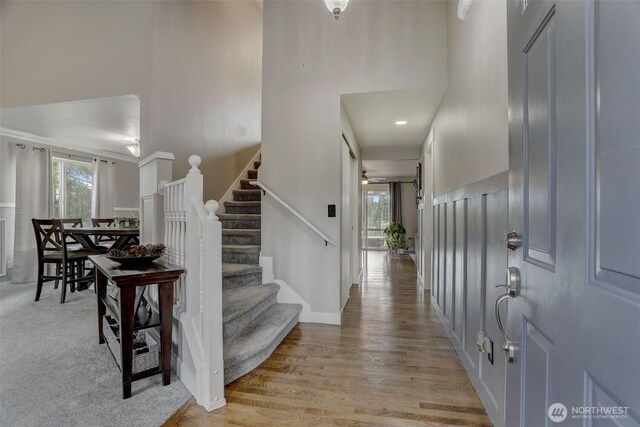 22506 SE 277th Pl, Maple Valley, WA 98038 - entryway featuring healthy amount of natural light, a high ceiling, stairs, and light wood-style floors