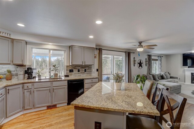 22506 SE 277th Pl, Maple Valley, WA 98038 - kitchen featuring black dishwasher, a sink, healthy amount of natural light, backsplash, and recessed lighting