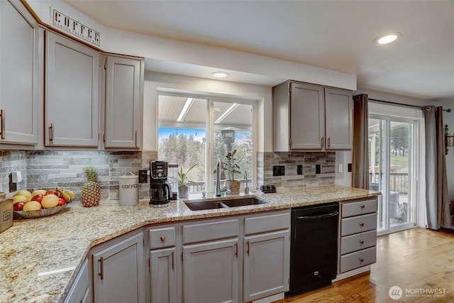 22506 SE 277th Pl, Maple Valley, WA 98038 - kitchen featuring dishwasher, a sink, tasteful backsplash, recessed lighting, and light wood-style floors