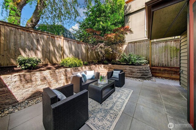 2648 NW 57th St Unit A, Seattle, WA 98107 - fenced backyard with a patio and outdoor lounge area