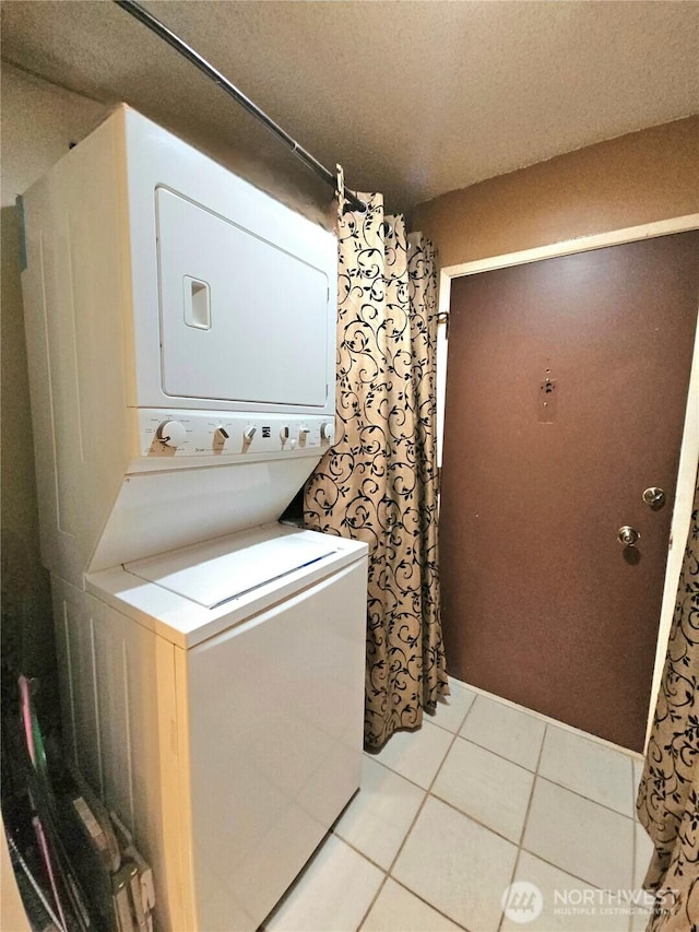 7924 212th St SW Unit 104, Edmonds, WA 98026 - washroom featuring estacked washer and dryer and light tile patterned floors