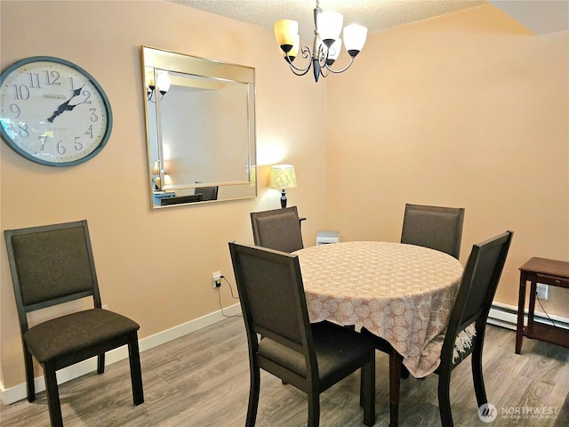 7924 212th St SW Unit 104, Edmonds, WA 98026 - dining room with light wood finished floors, baseboard heating, a chandelier, and a textured ceiling
