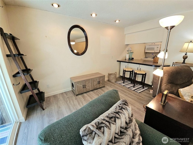 7924 212th St SW Unit 104, Edmonds, WA 98026 - living room featuring light wood-style floors and recessed lighting