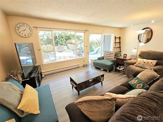 7924 212th St SW Unit 104, Edmonds, WA 98026 - living area featuring a baseboard radiator, a textured ceiling, and wood finished floors