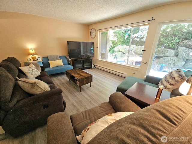 7924 212th St SW Unit 104, Edmonds, WA 98026 - living area featuring baseboard heating, wood finished floors, healthy amount of natural light, and a textured ceiling