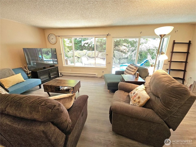 7924 212th St SW Unit 104, Edmonds, WA 98026 - living room featuring a baseboard heating unit, wood finished floors, and a textured ceiling