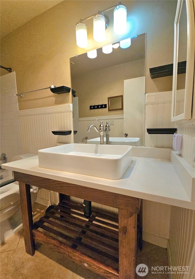 7924 212th St SW Unit 104, Edmonds, WA 98026 - bathroom with a wainscoted wall,  shower combination, vanity, tile patterned flooring, and a decorative wall
