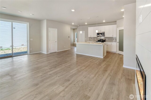 18226 37th Ave E, Tacoma, WA 98446 - kitchen with appliances with stainless steel finishes, light wood-style flooring, light countertops, open floor plan, and recessed lighting