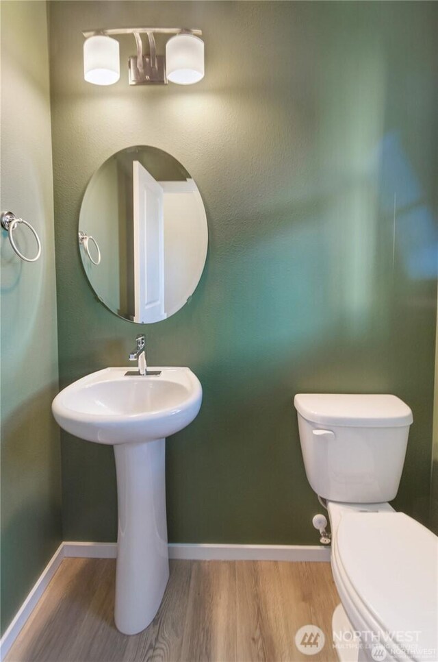 18226 37th Ave E, Tacoma, WA 98446 - bathroom with wood finished floors, toilet, and baseboards