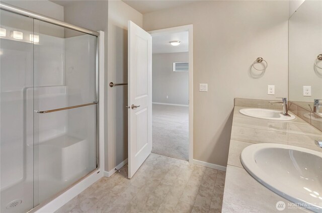 18226 37th Ave E, Tacoma, WA 98446 - bathroom featuring a stall shower, double vanity, and baseboards