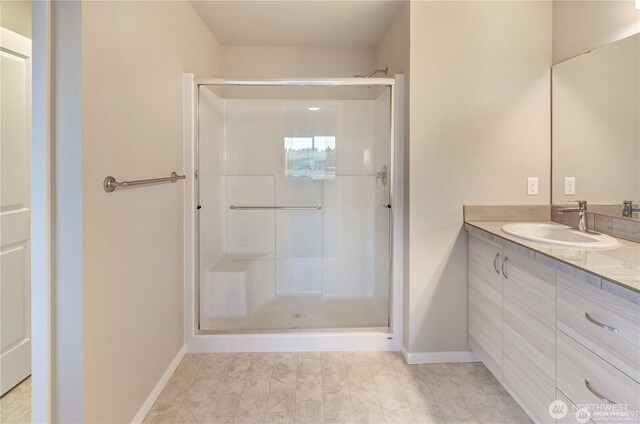 18226 37th Ave E, Tacoma, WA 98446 - bathroom featuring a stall shower, vanity, and baseboards