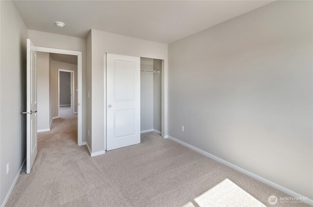 18226 37th Ave E, Tacoma, WA 98446 - unfurnished bedroom with light carpet, baseboards, and a closet