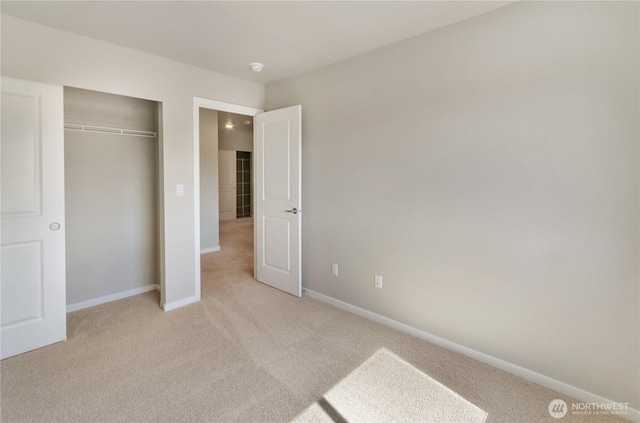 18226 37th Ave E, Tacoma, WA 98446 - unfurnished bedroom with light colored carpet, baseboards, and a closet