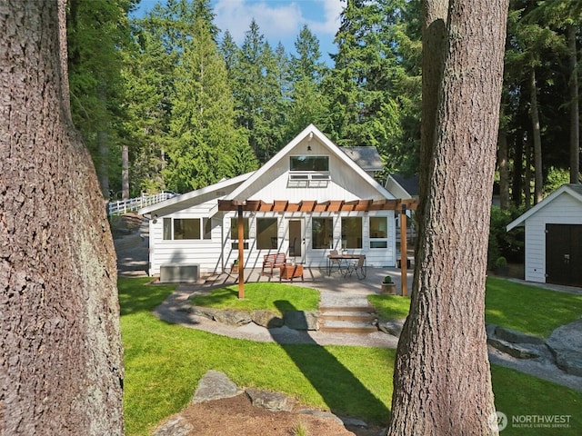 7511 230th Ave NE, Redmond, WA 98053 - back of house featuring a pergola, a patio area, central AC unit, a lawn, and board and batten siding