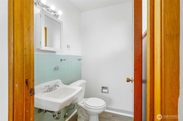 9023 Mcconnell Dr Unit B, Moses Lake, WA 98837 - half bathroom with toilet, tile walls, wainscoting, wood finished floors, and a sink