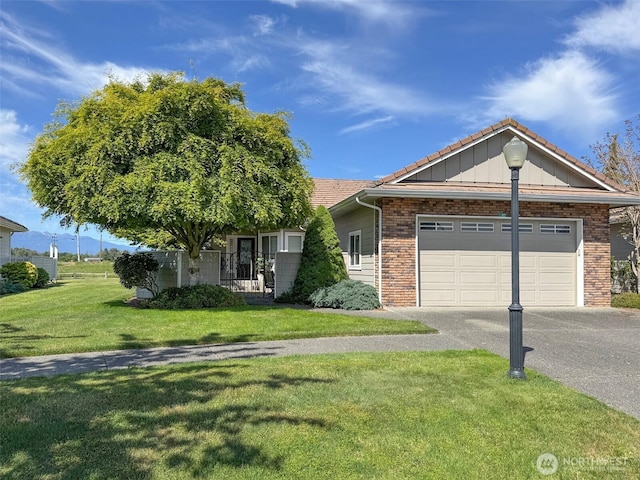 40 Cascadia Loop, Sequim, WA 98382 - ranch-style home featuring driveway, a front lawn, board and batten siding, an attached garage, and brick siding