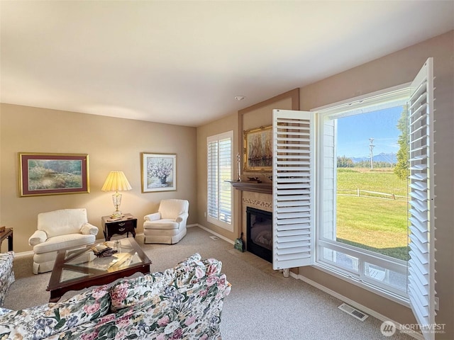 40 Cascadia Loop, Sequim, WA 98382 - carpeted living room featuring plenty of natural light, a glass covered fireplace, and baseboards