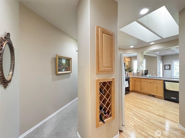 40 Cascadia Loop, Sequim, WA 98382 - bathroom featuring recessed lighting, baseboards, vanity, wood finished floors, and a skylight
