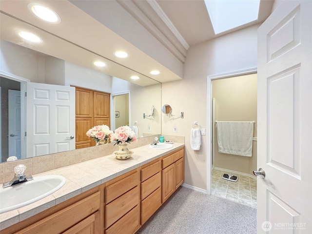 40 Cascadia Loop, Sequim, WA 98382 - full bathroom with double vanity, recessed lighting, a skylight, and baseboards