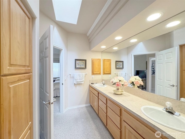40 Cascadia Loop, Sequim, WA 98382 - ensuite bathroom with a skylight, double vanity, baseboards, and recessed lighting