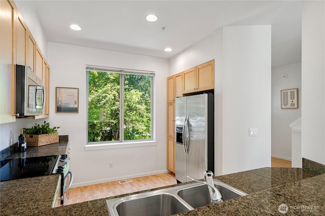 2141 NW Boulder Way Dr, Issaquah, WA 98027 - kitchen with appliances with stainless steel finishes, a sink, light brown cabinets, light wood-type flooring, and tile counters