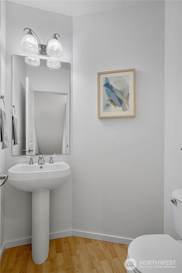 2141 NW Boulder Way Dr, Issaquah, WA 98027 - bathroom with toilet, baseboards, wood finished floors, and a sink