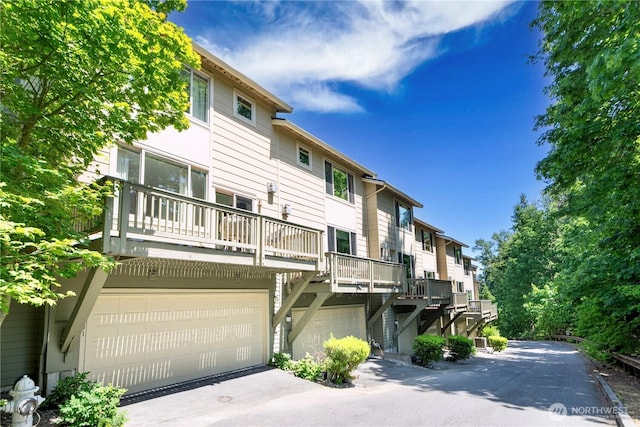 2141 NW Boulder Way Dr, Issaquah, WA 98027 - back of property with an attached garage, stairs, and asphalt driveway