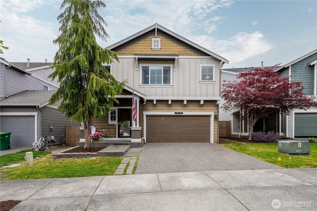 7615 14th St SE, Lake Stevens, WA 98258 - view of front facade featuring board and batten siding, asphalt driveway, an attached garage, and a front yard