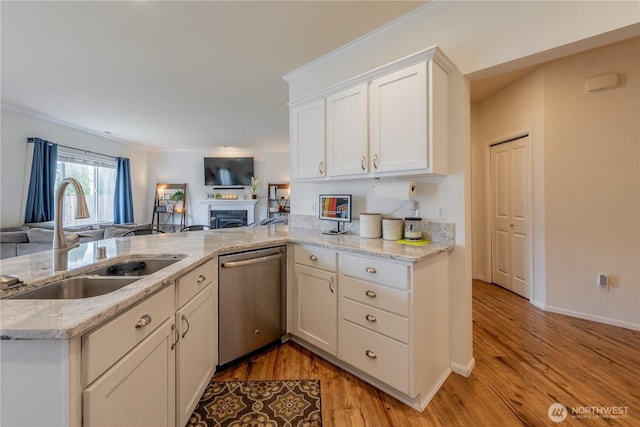 7615 14th St SE, Lake Stevens, WA 98258 - kitchen with dishwasher, a sink, open floor plan, a fireplace, and white cabinetry