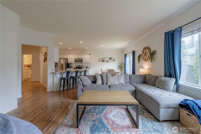 7615 14th St SE, Lake Stevens, WA 98258 - living room featuring plenty of natural light, light wood-type flooring, crown molding, recessed lighting, and baseboards