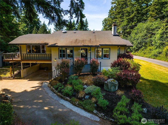 3536 Arbor St, Bellingham, WA 98229 - view of front facade featuring a chimney, driveway, a porch, a carport, and a shingled roof