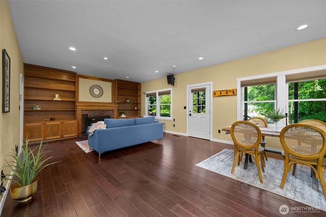 3536 Arbor St, Bellingham, WA 98229 - living room with a brick fireplace, dark wood finished floors, built in shelves, baseboards, and recessed lighting
