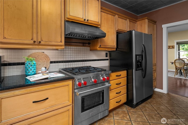 3536 Arbor St, Bellingham, WA 98229 - kitchen with appliances with stainless steel finishes, under cabinet range hood, dark countertops, backsplash, and dark tile patterned floors