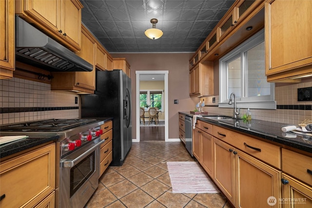 3536 Arbor St, Bellingham, WA 98229 - kitchen with appliances with stainless steel finishes, a sink, under cabinet range hood, light tile patterned floors, and decorative backsplash