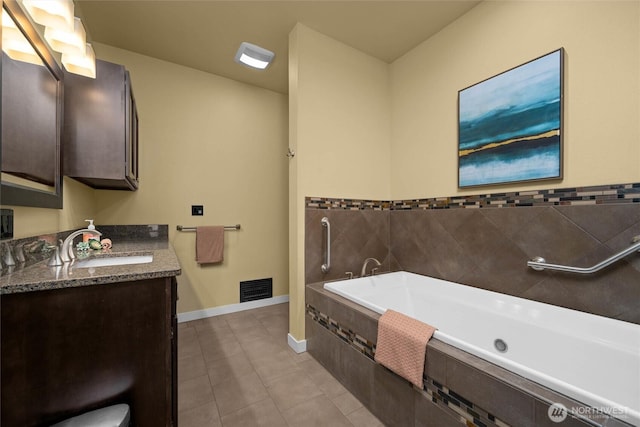 3536 Arbor St, Bellingham, WA 98229 - bathroom featuring a garden tub, tile patterned floors, vanity, and baseboards