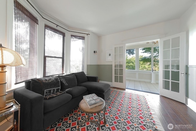 2560 Gilman Dr W, Seattle, WA 98119 - living room with wood finished floors, a wainscoted wall, and french doors