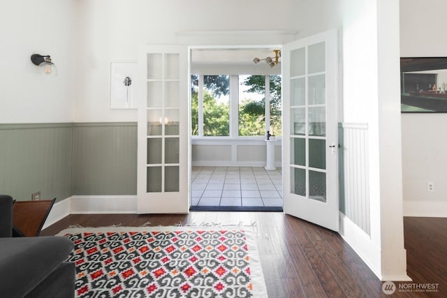 2560 Gilman Dr W, Seattle, WA 98119 - entryway with french doors, wood finished floors, wainscoting, a chandelier, and baseboards