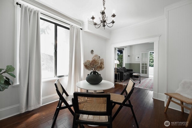 2560 Gilman Dr W, Seattle, WA 98119 - dining area featuring a chandelier, crown molding, dark wood-style flooring, and baseboards