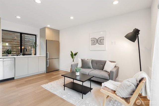 3240 32nd Ave W Unit B, Seattle, WA 98199 - living area with light wood-style flooring, recessed lighting, baseboards, and wet bar