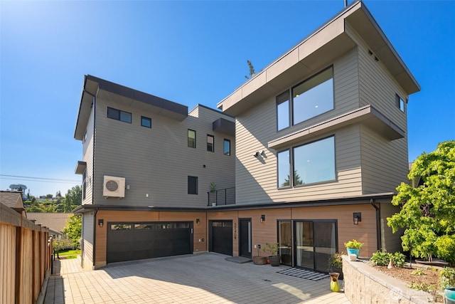 3240 32nd Ave W Unit B, Seattle, WA 98199 - back of house featuring an attached garage and driveway