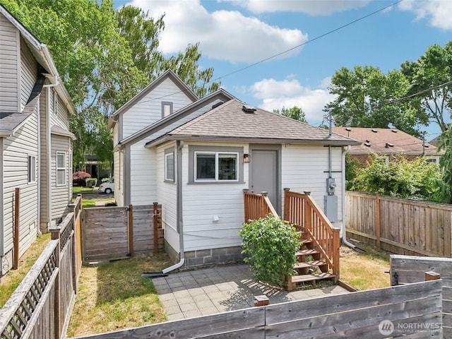 1022 N Anderson St, Tacoma, WA 98406 - back of house with roof with shingles, a fenced backyard, and a patio area