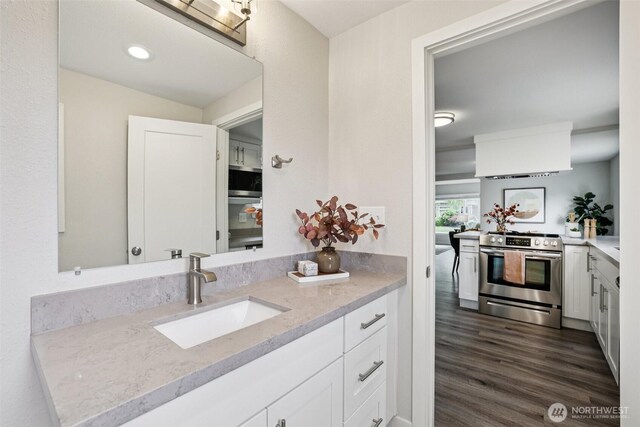 1022 N Anderson St, Tacoma, WA 98406 - bathroom featuring vanity, wood finished floors, and recessed lighting